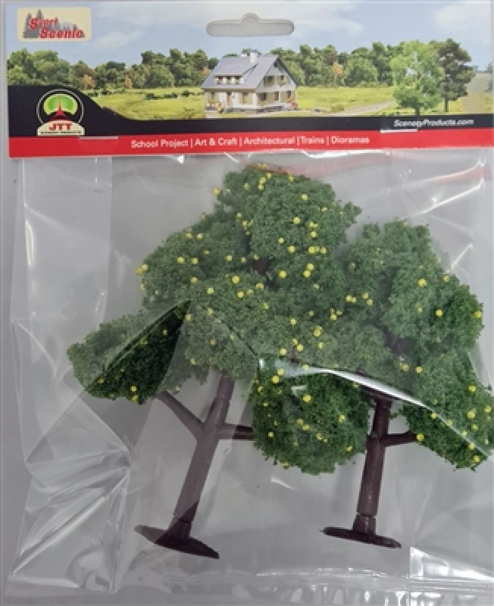 Two artificial green trees in a clear plastic package with red label header.