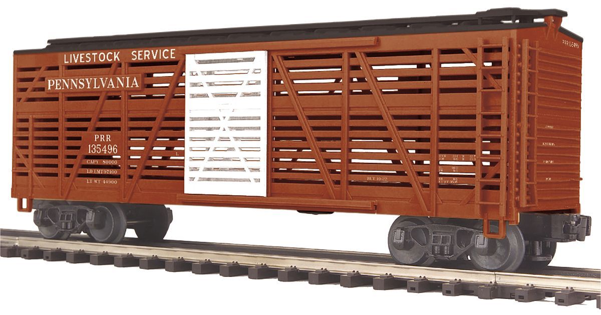 Brown livestock railcar on tracks, with white lettering and a centered shipping label.