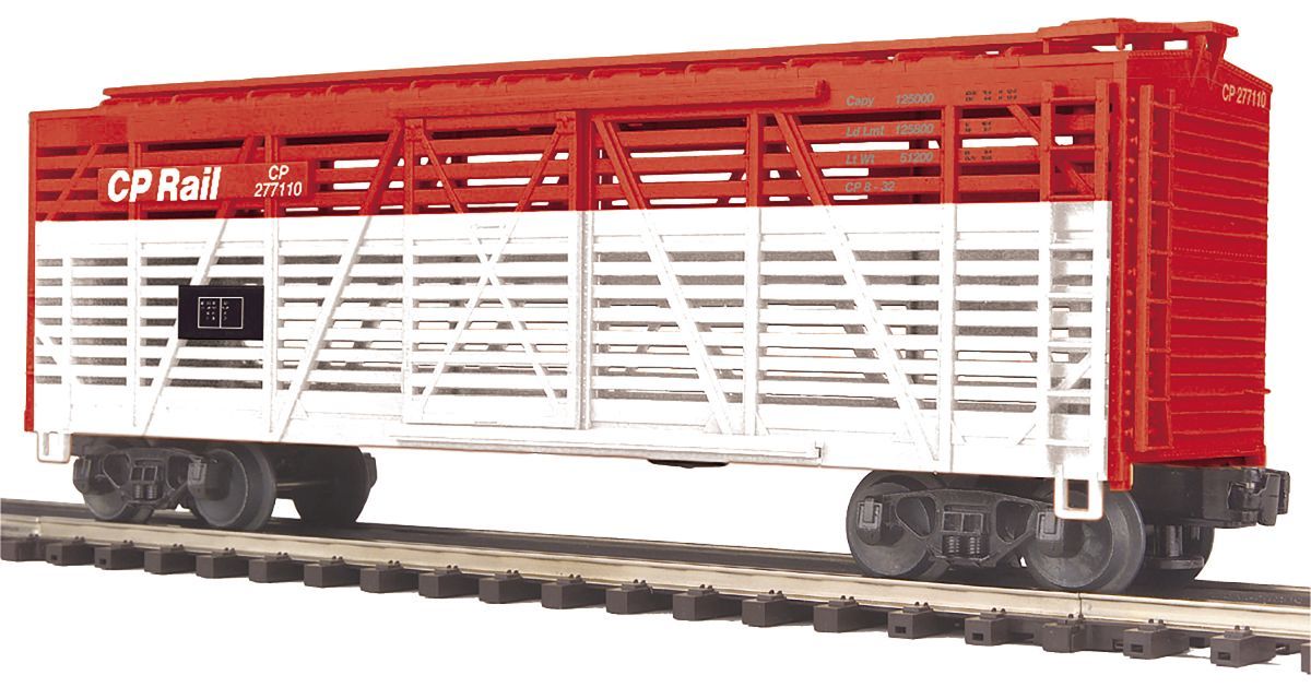 Red and white CP Rail livestock train car on tracks, side view