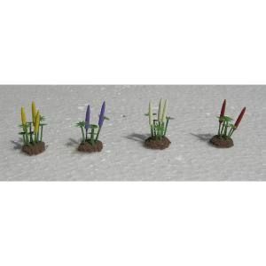 Four small potted LEGO-like plants with yellow, purple, green, and red stems on a gray surface