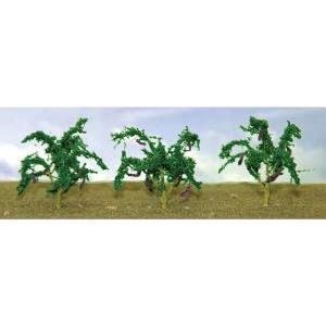 Three small green model trees on a brown ground against a white background.