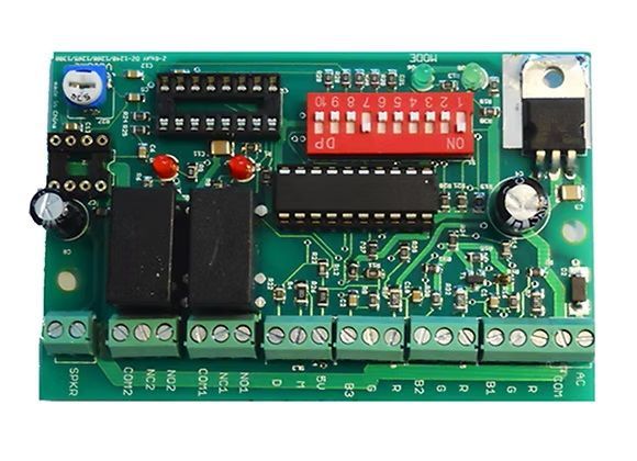 Green electronic circuit board with red DIP switches, relays, terminals, and capacitors