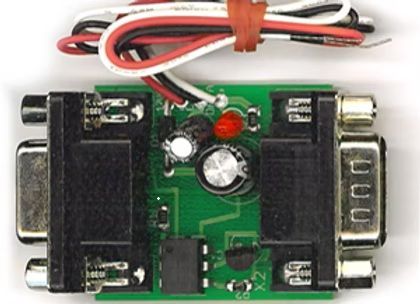 Small green electronic circuit board with connectors, wires, and ports on both ends