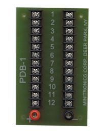 Green PDB-1 terminal board with numbered screw terminals and labels for interior/security power connections