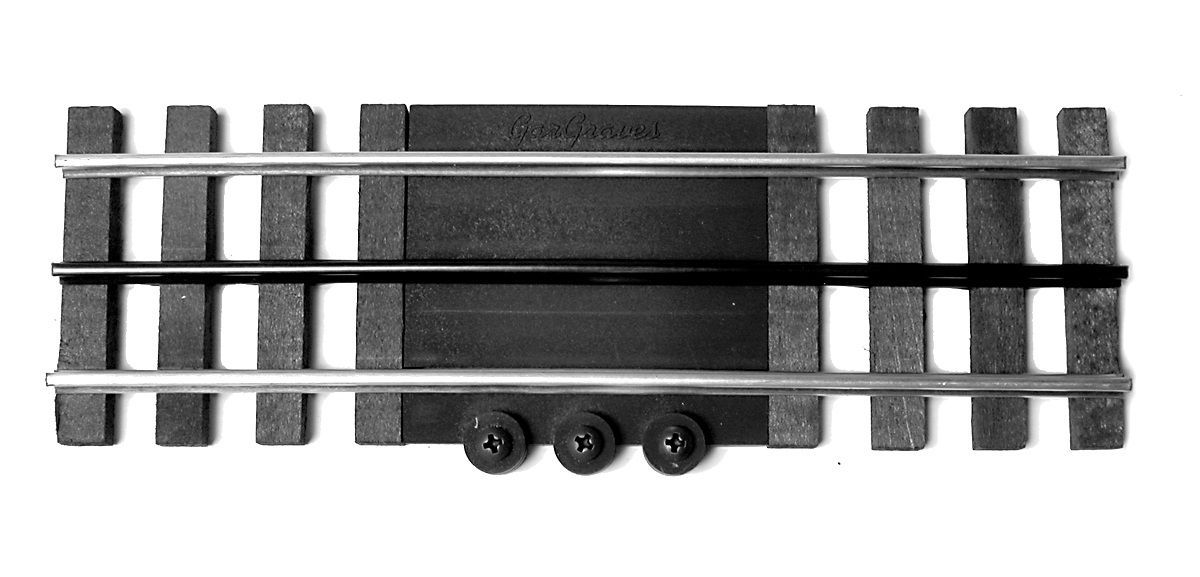 Black metal train track crossing sensor with three small wheels underneath and rails on both sides