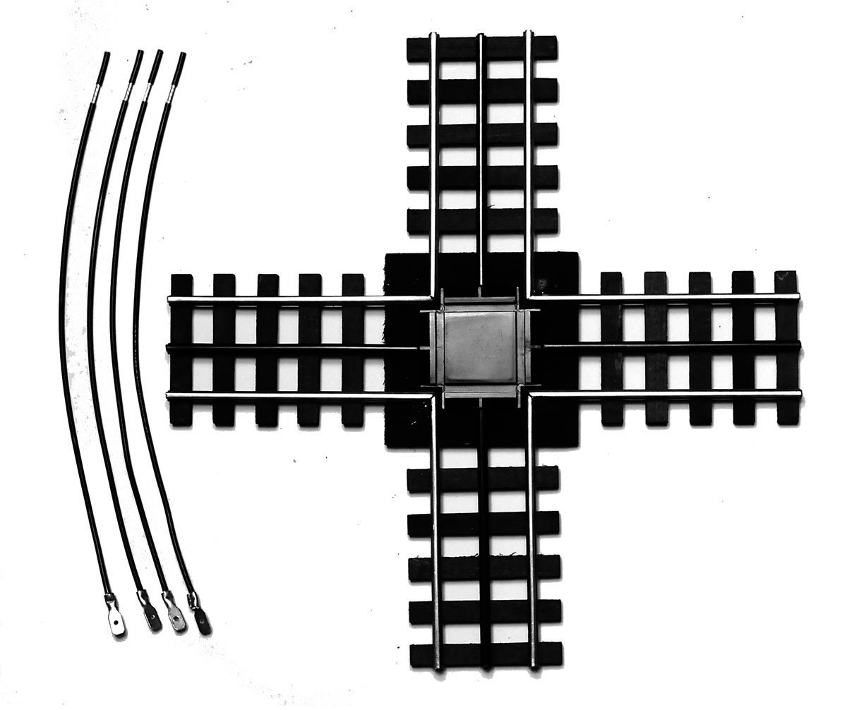 Black railroad crossing track arrangement with a central junction and curved rails on the left