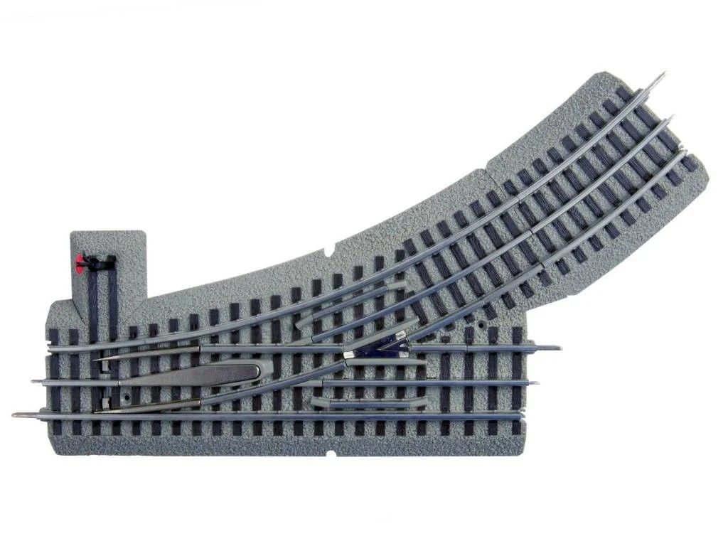 Curved gray model train track with multiple switches and straight crossing rails