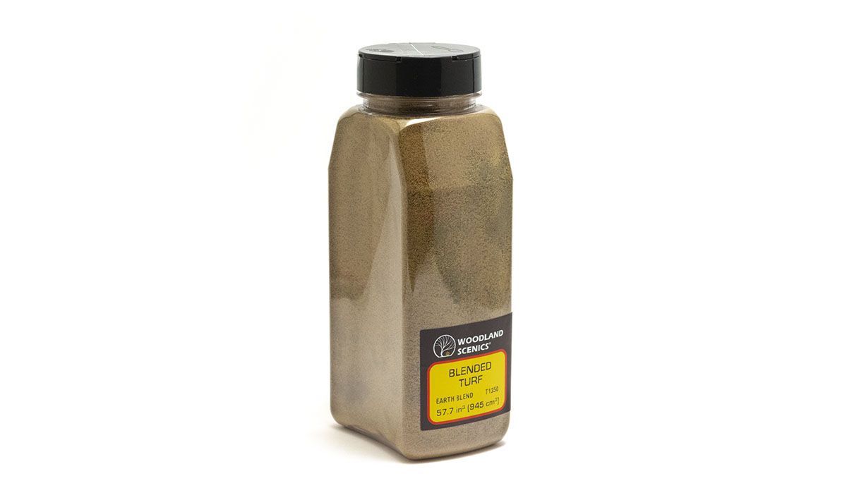 Tan pepper shaker with black lid and yellow label on white background