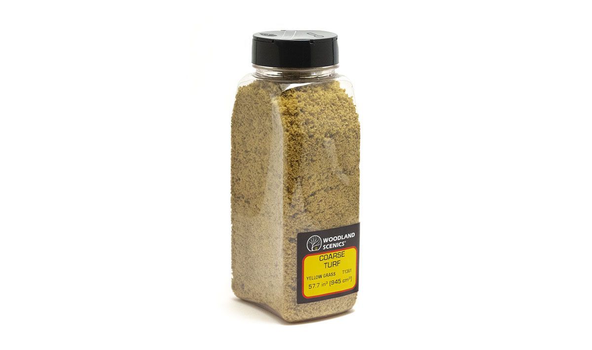 Clear plastic spice jar with black lid, filled with dried herbs, on a white background