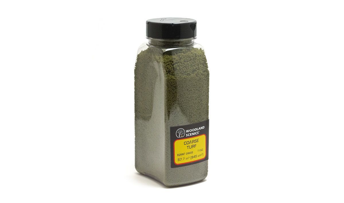 Clear plastic spice jar with a black lid and yellow label, filled with green dried herbs.