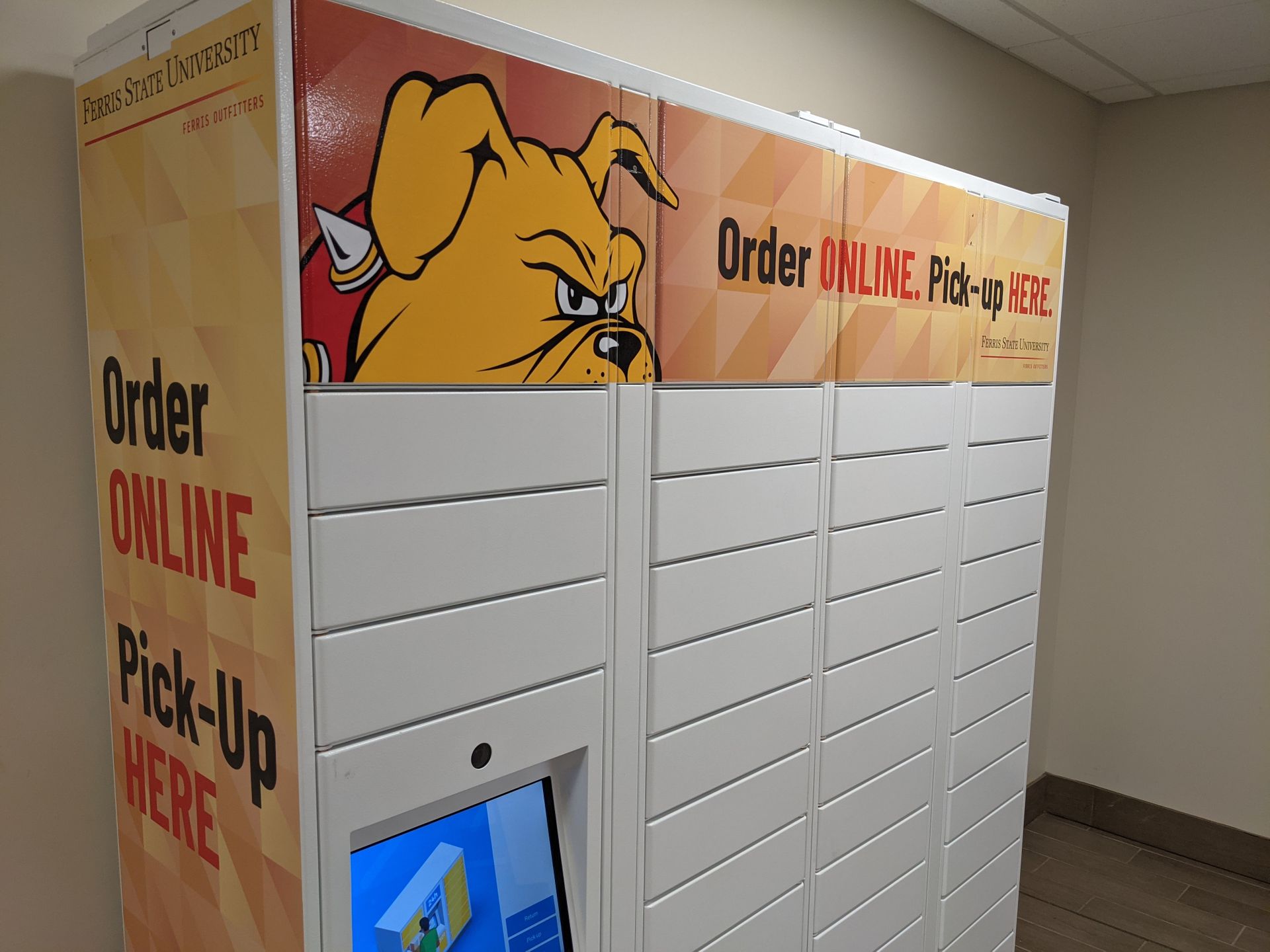 White online order pickup lockers with touchscreen and bulldog logo on top.