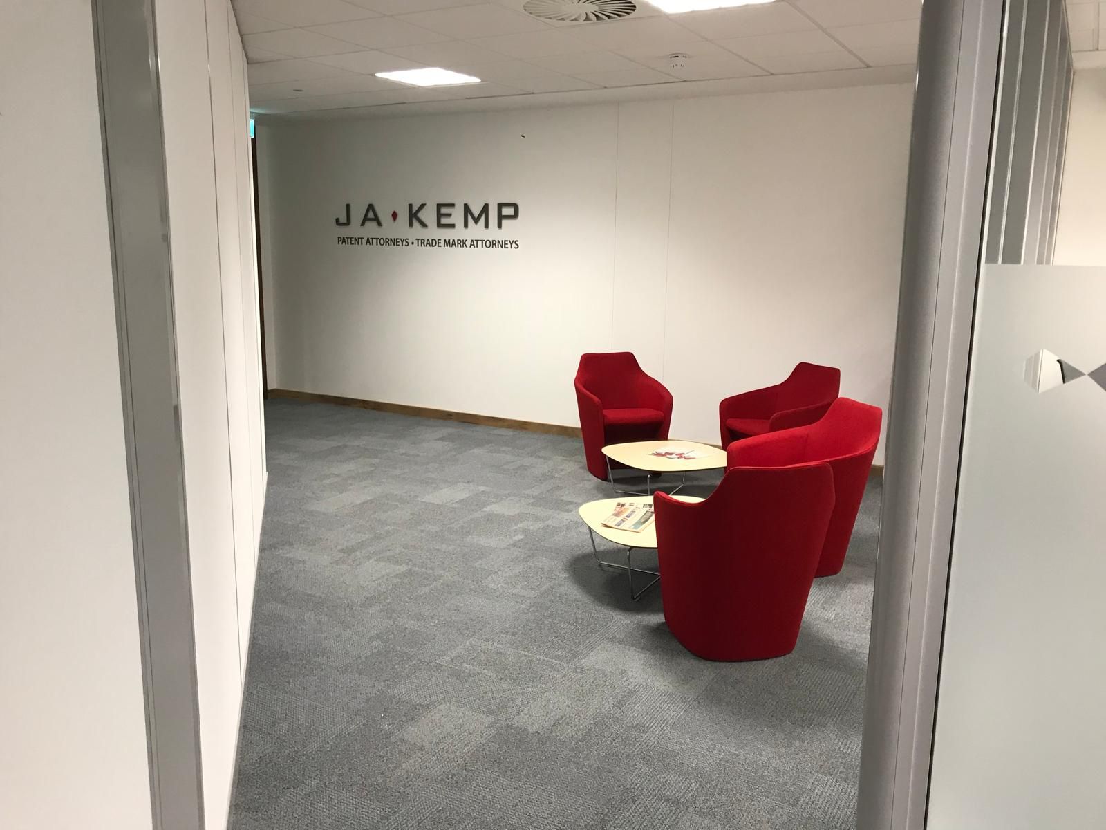 Empty office with wood floors, desks, windows, and a black-and-white wall mural