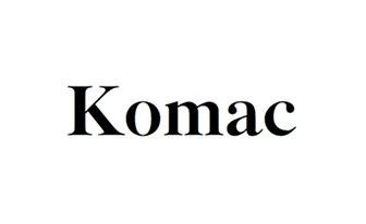 Black text reading “Komac” on a white background
