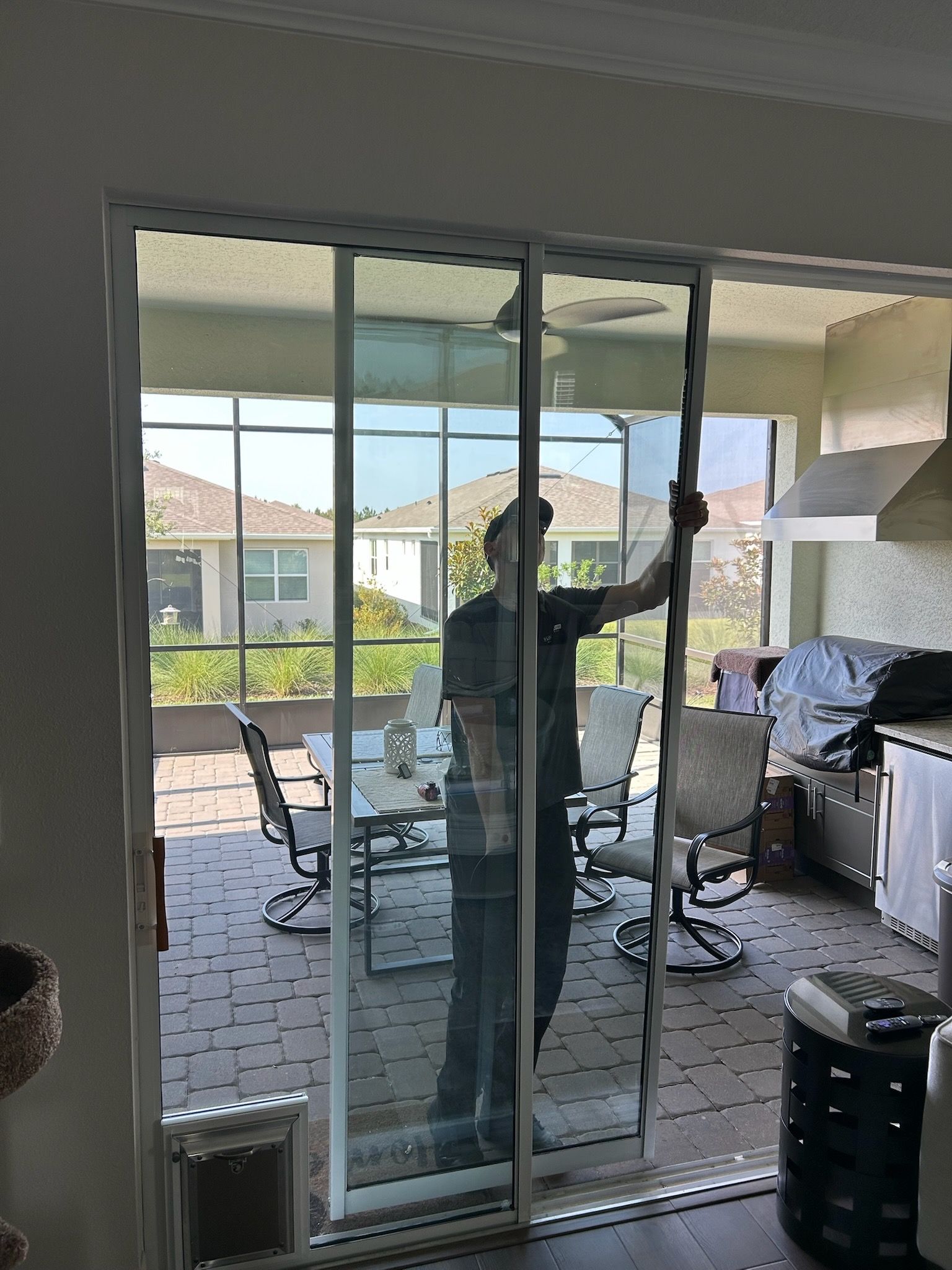 Licensed contractor installing sliding glass door with insulated glass for energy savings