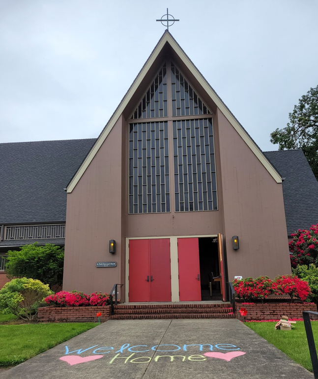 St. Paul's church on a cloudy day, as viewed from Meyer's Street. The red front doors are open and