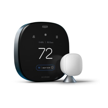 Black smart thermostat showing 72°F beside a white sensor on a white background