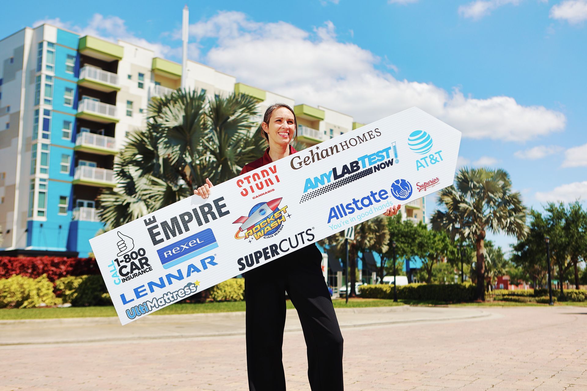 A woman is holding a sign that says the empire