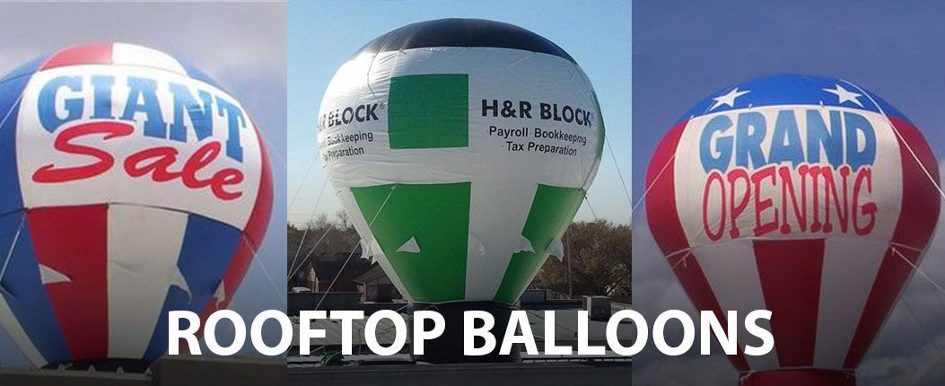 Three rooftop balloons are flying in the sky.