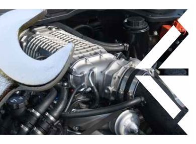 A close up of a car engine with a wrench on it. | C & G Auto Center Inc