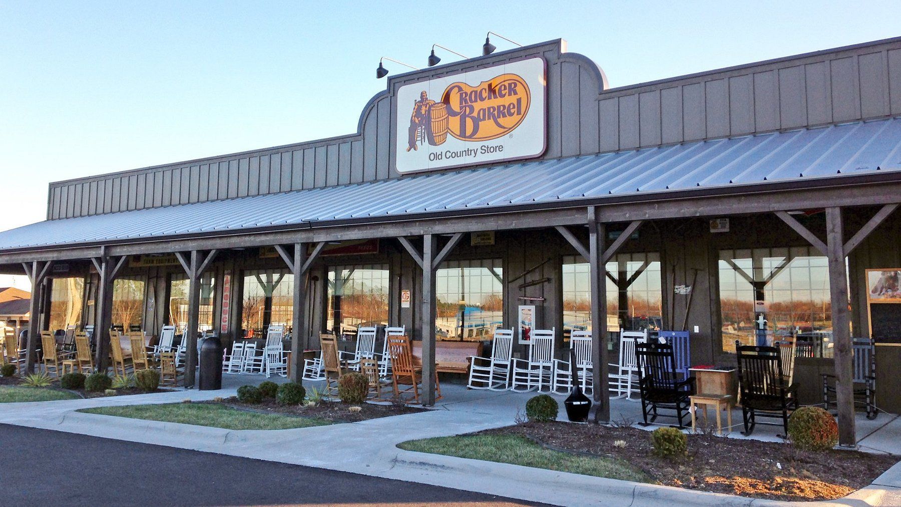 Cracker Barrel restaurant exterior with rocking chairs on the porch.