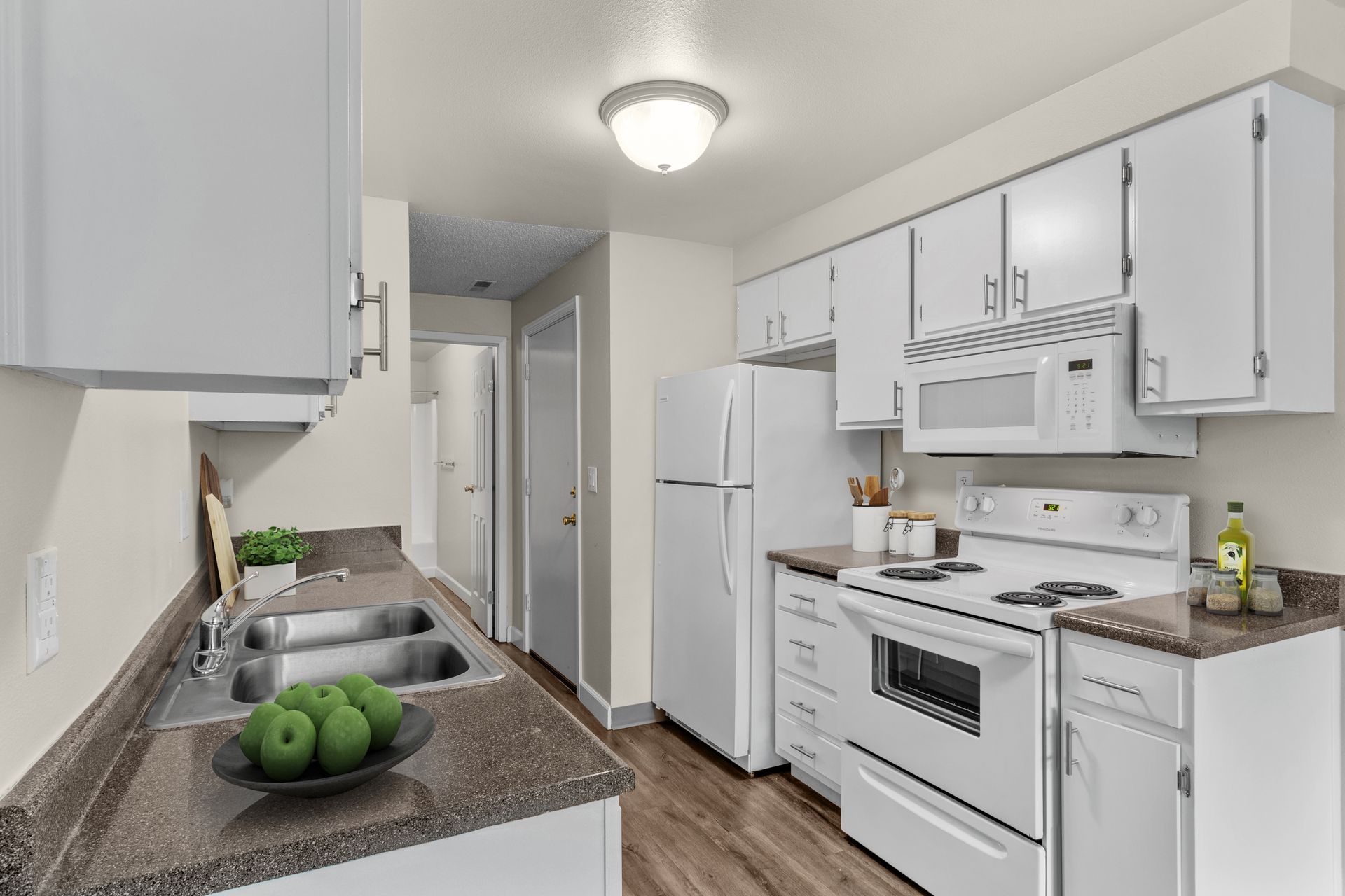 spacious kitchen with dishwasher, microwave, range, and refrigerator