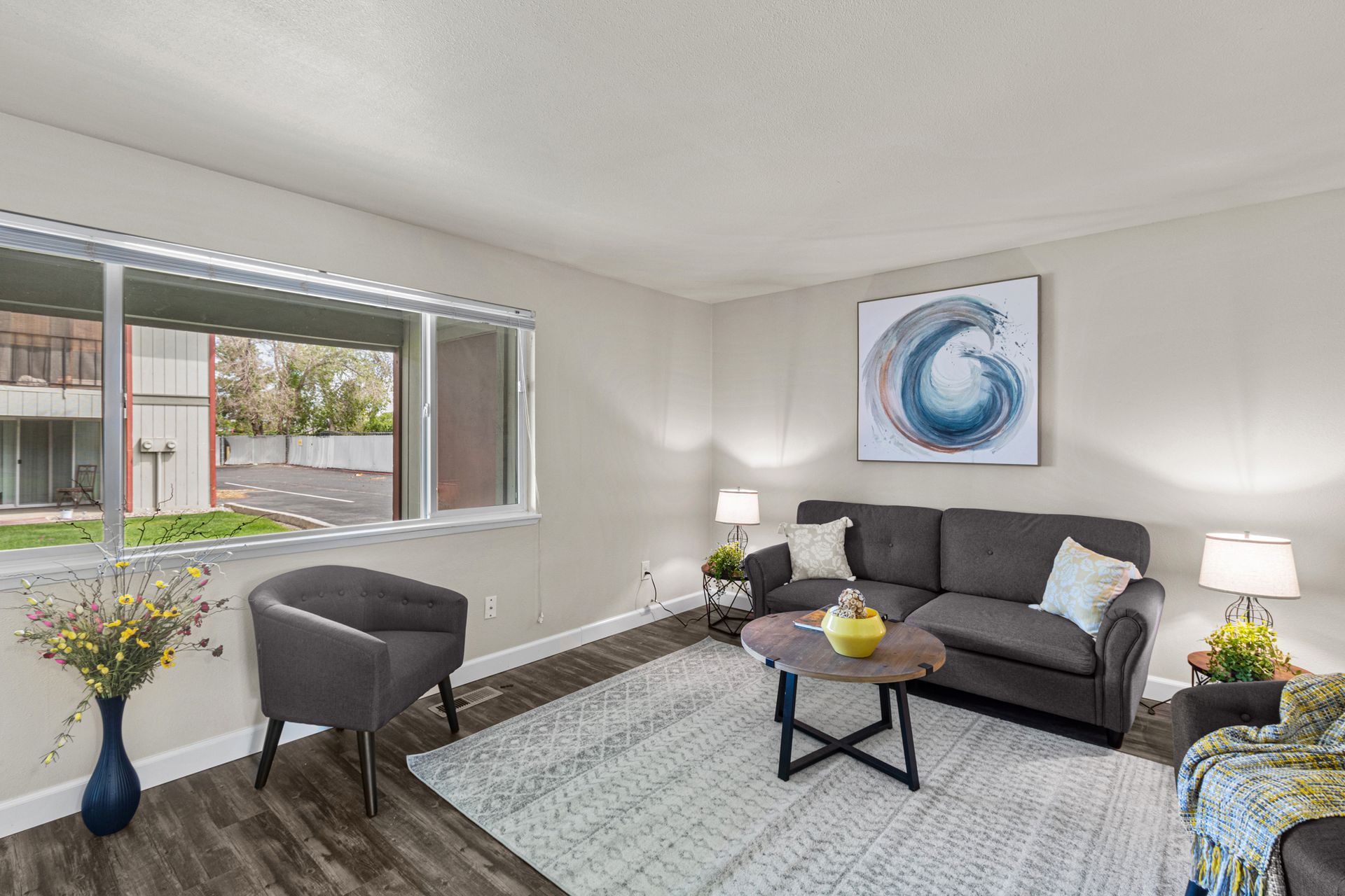 spacious living room area with large window