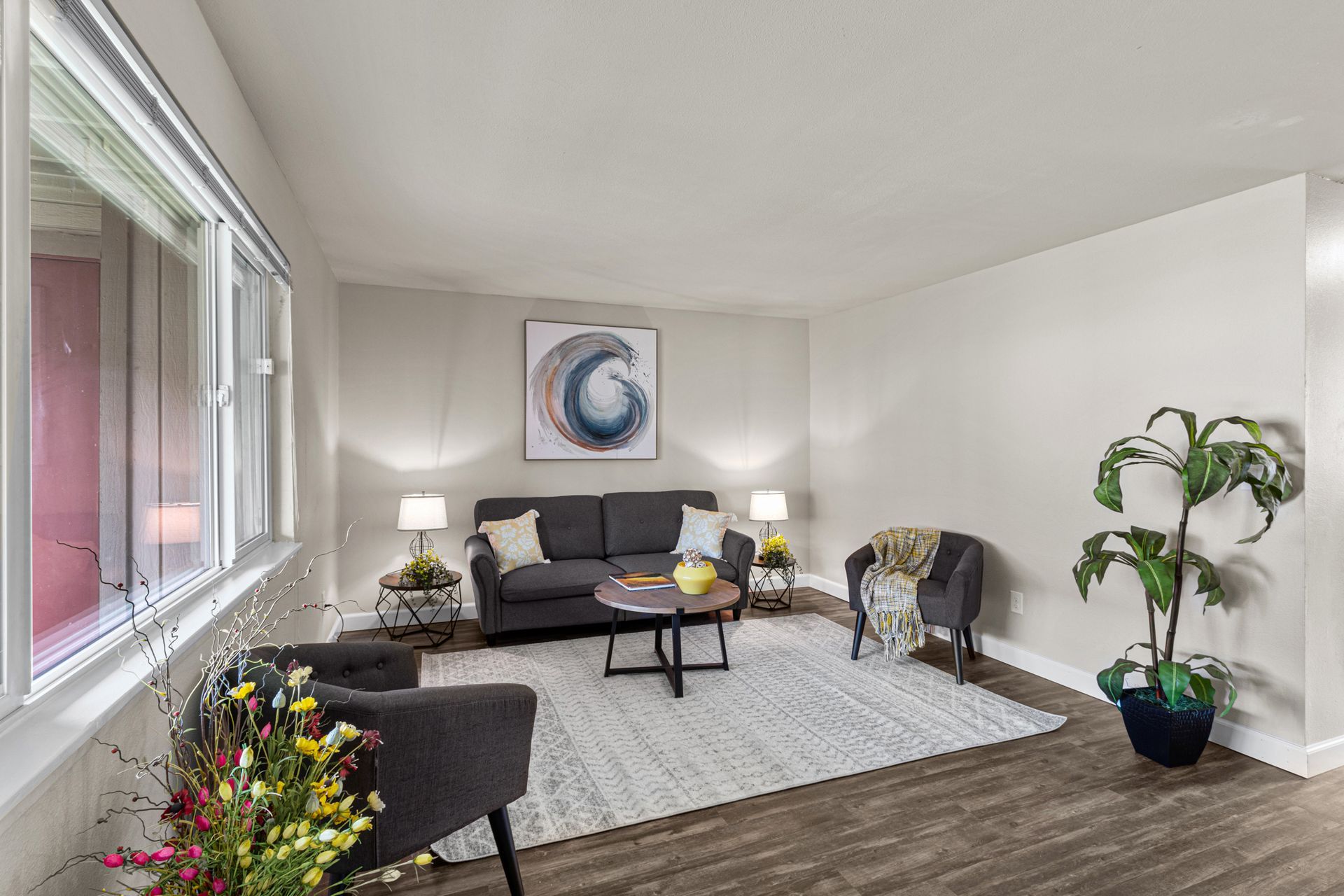 spacious living room area with large window