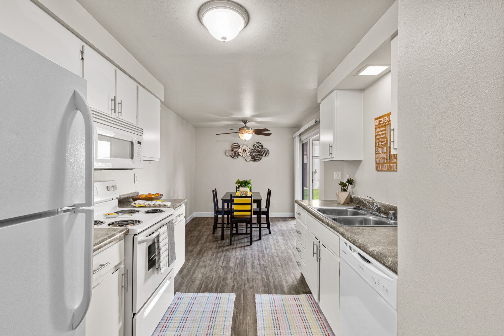 spacious kitchen with dishwasher, microwave, range, and refrigerator