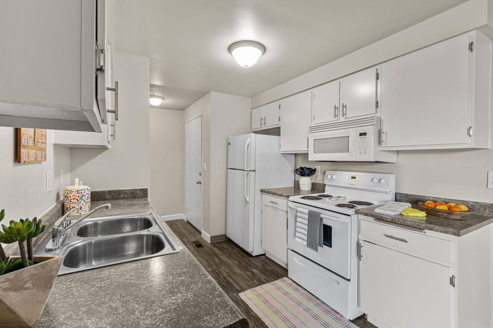 spacious kitchen with dishwasher, microwave, range, and refrigerator