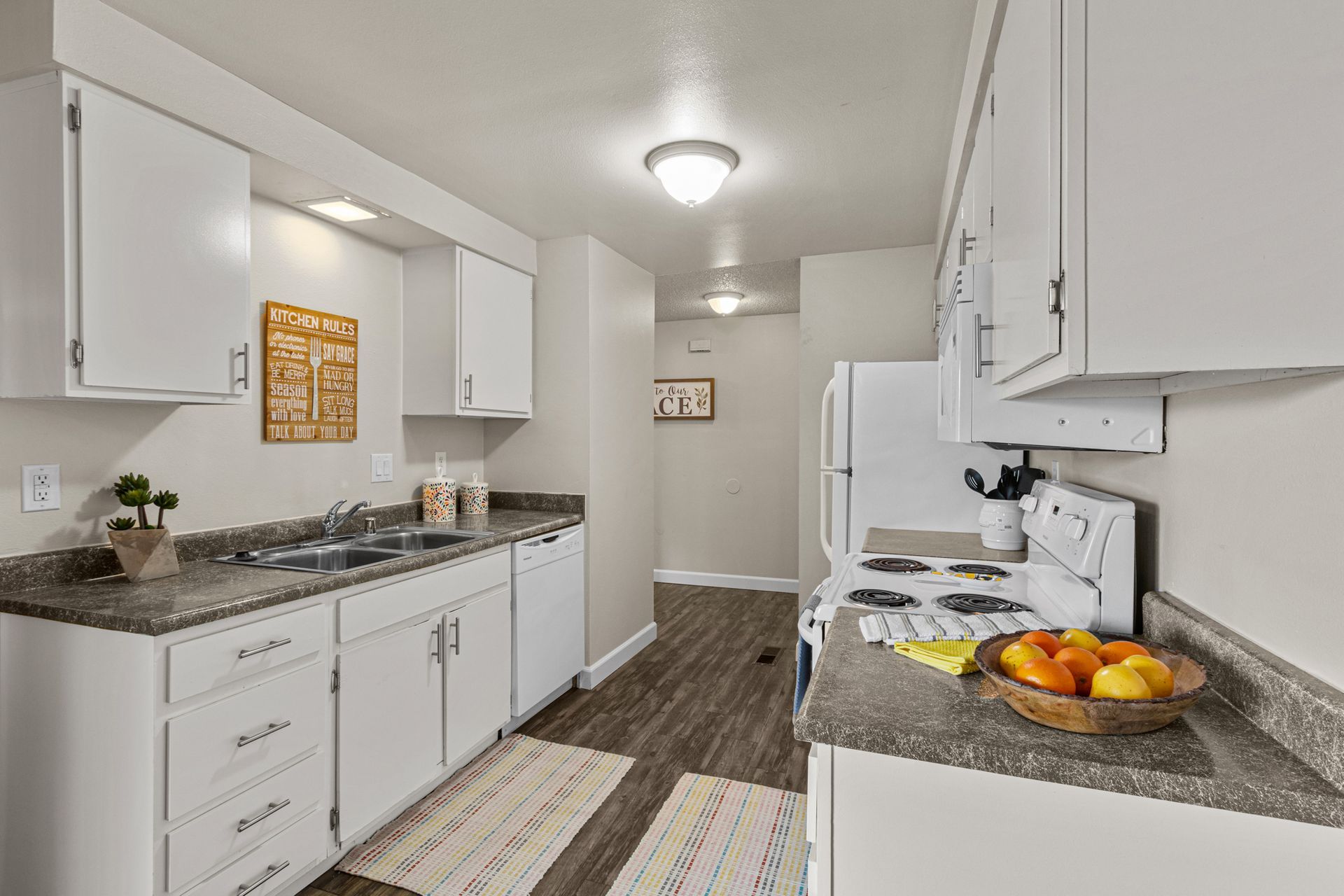 spacious kitchen with dishwasher, microwave, range, and refrigerator