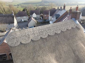 a residential house with a thatched roof