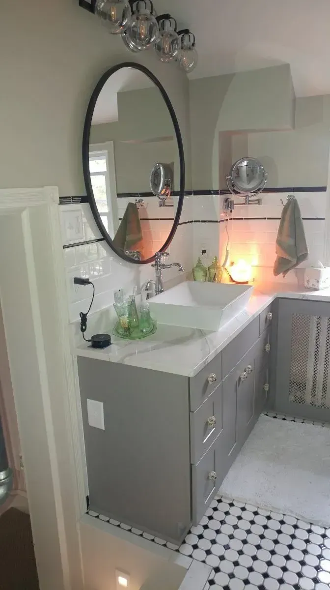 A bathroom with a sink and a mirror on the wall.