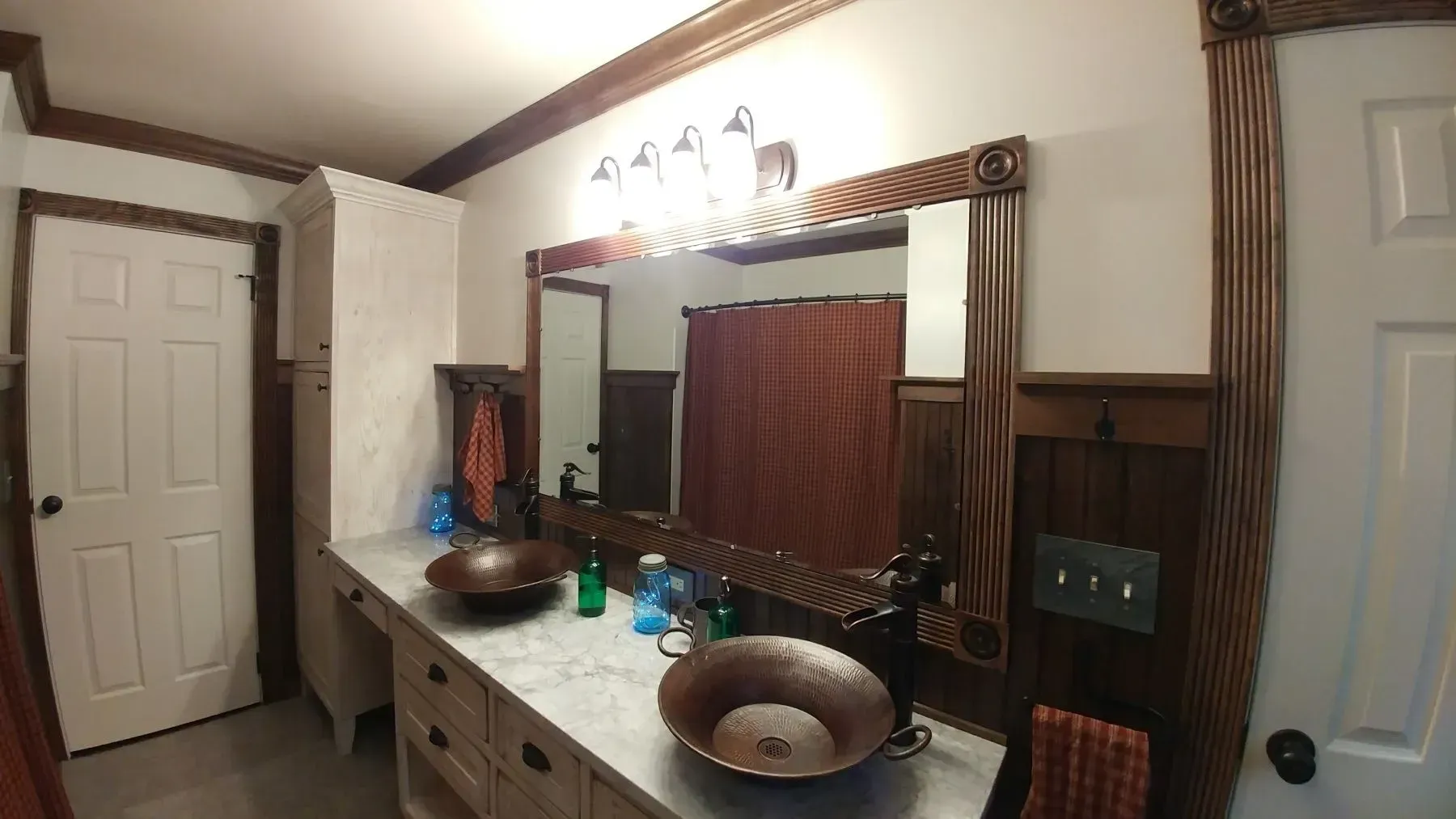 A bathroom with two sinks and two mirrors.