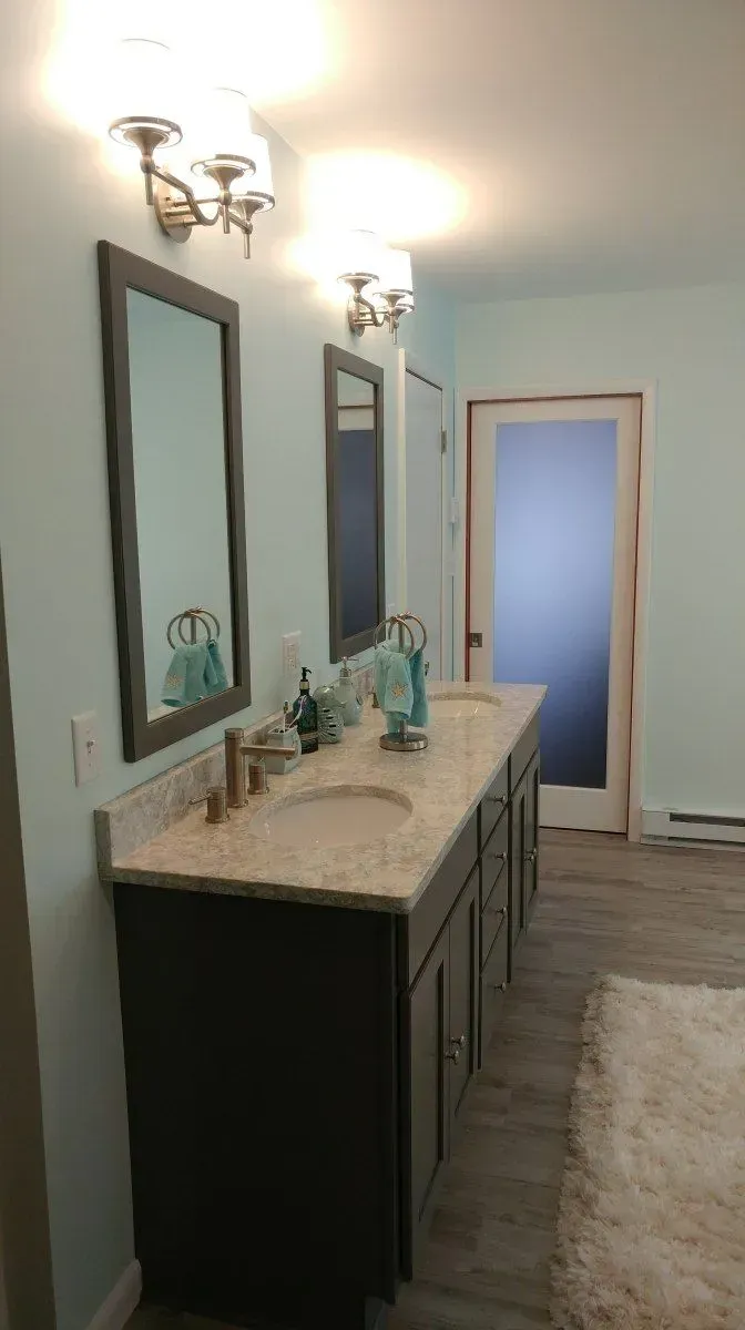 A bathroom with two sinks and two mirrors.