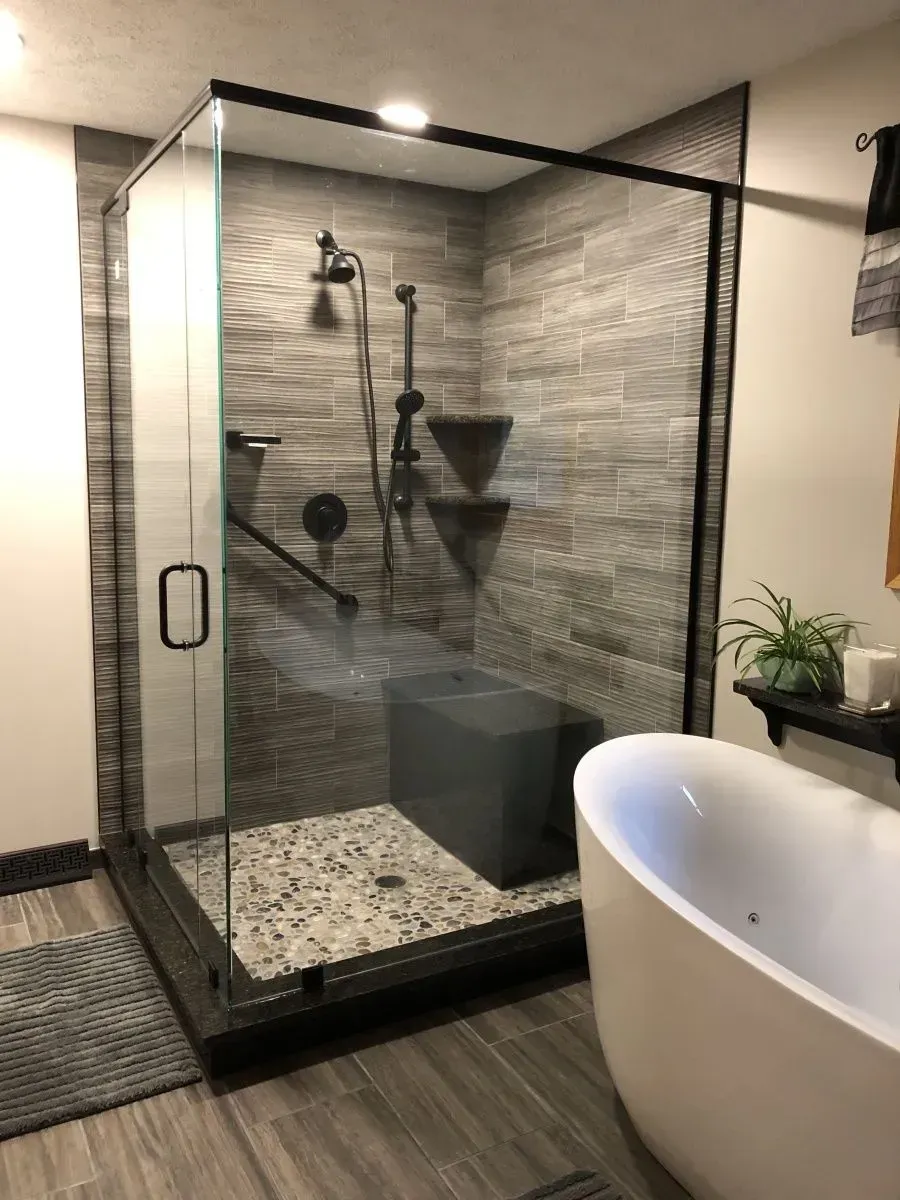 A bathroom with a walk in shower and a bathtub.