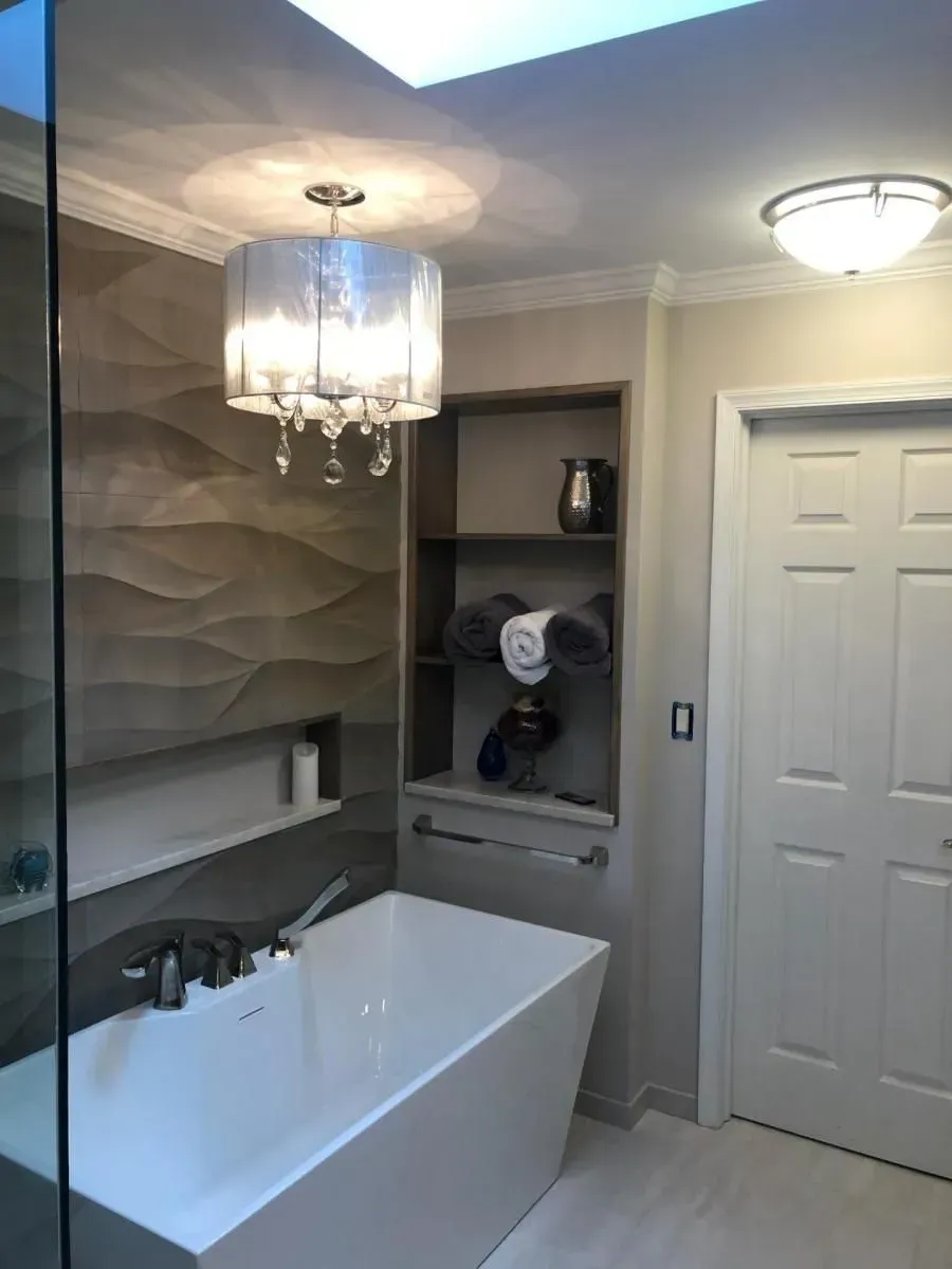 A bathroom with a bathtub and a chandelier hanging from the ceiling