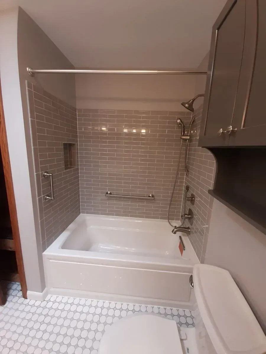 A bathroom with a bathtub and a toilet
