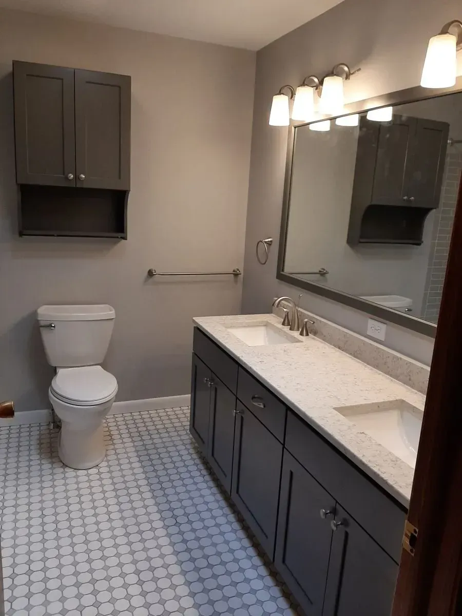 A bathroom with a toilet a sink and a mirror