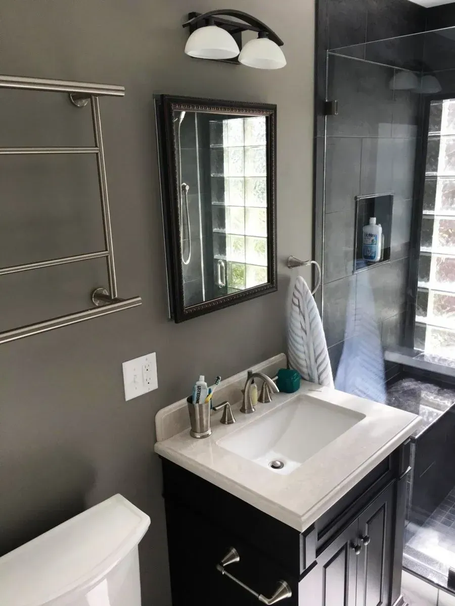 A bathroom with a sink , toilet and mirror