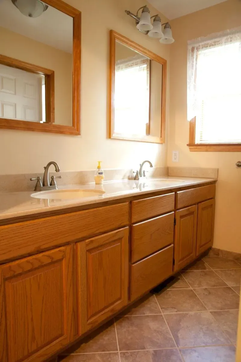 A bathroom with two sinks and two mirrors