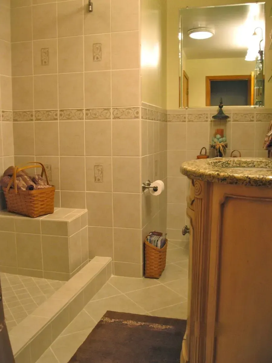 A bathroom with a sink and a walk in shower