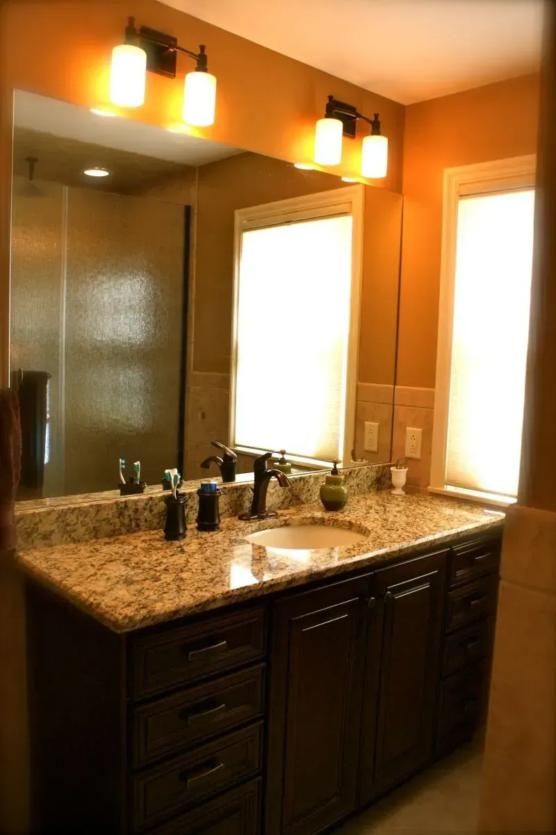 A bathroom with two sinks and a large mirror