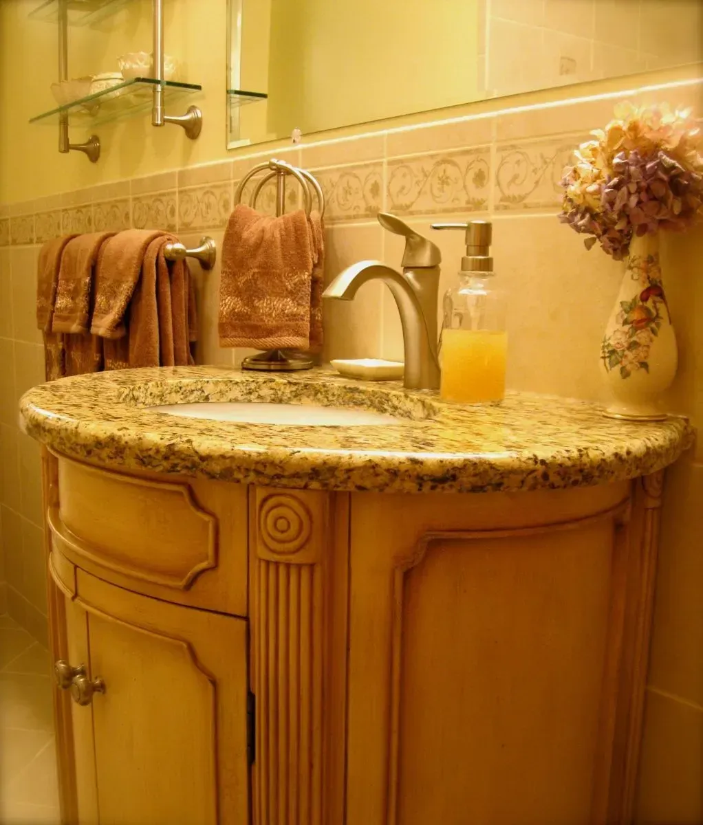 A bathroom with a sink and a vase of flowers