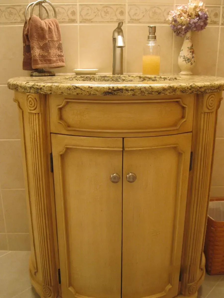 A bathroom vanity with a sink and soap dispenser