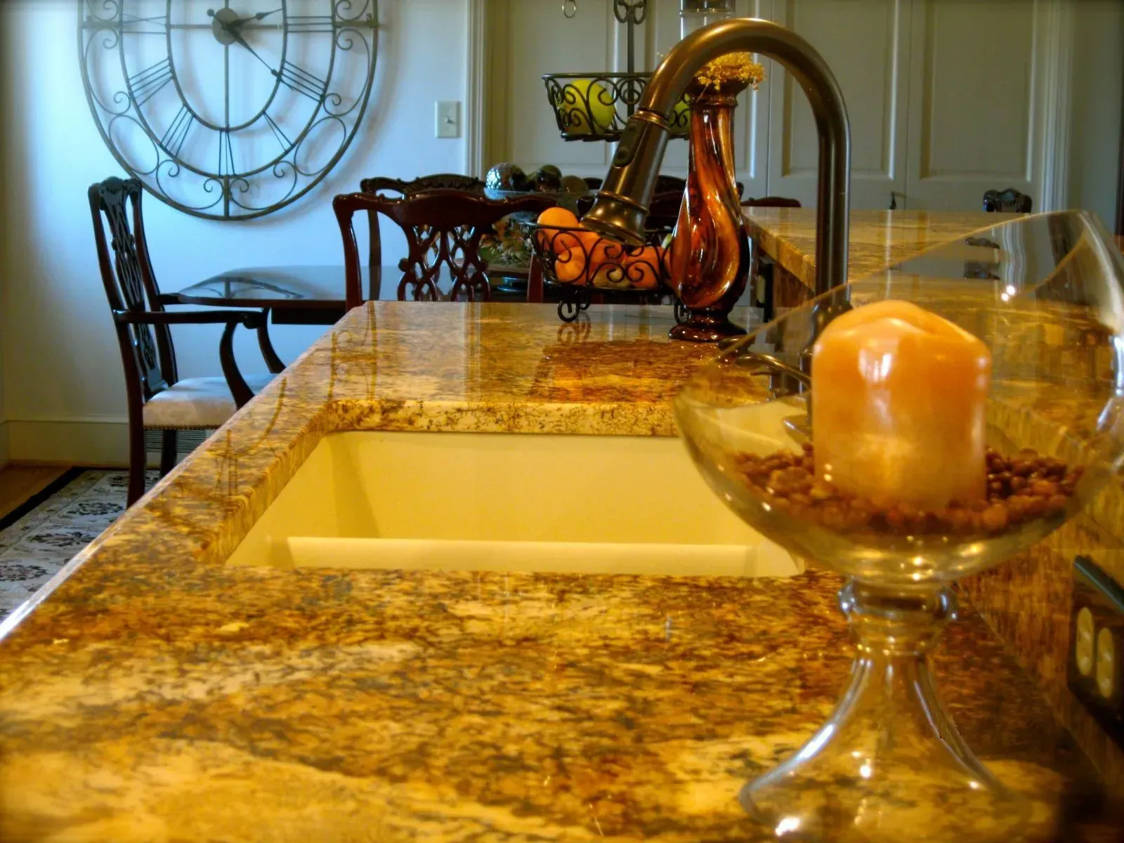 A kitchen counter with a sink and a candle on it
