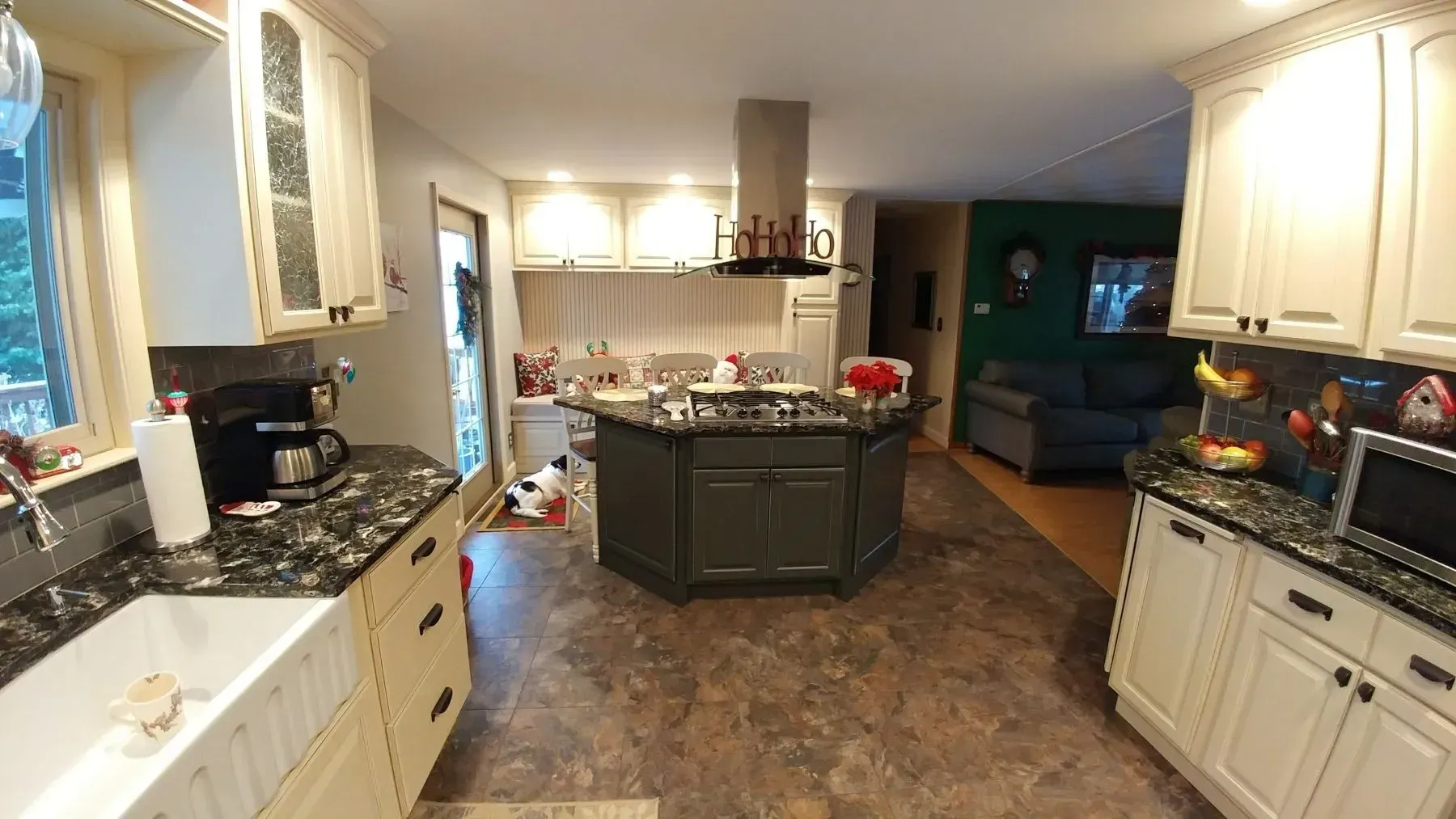 A kitchen with white cabinets and granite counter tops