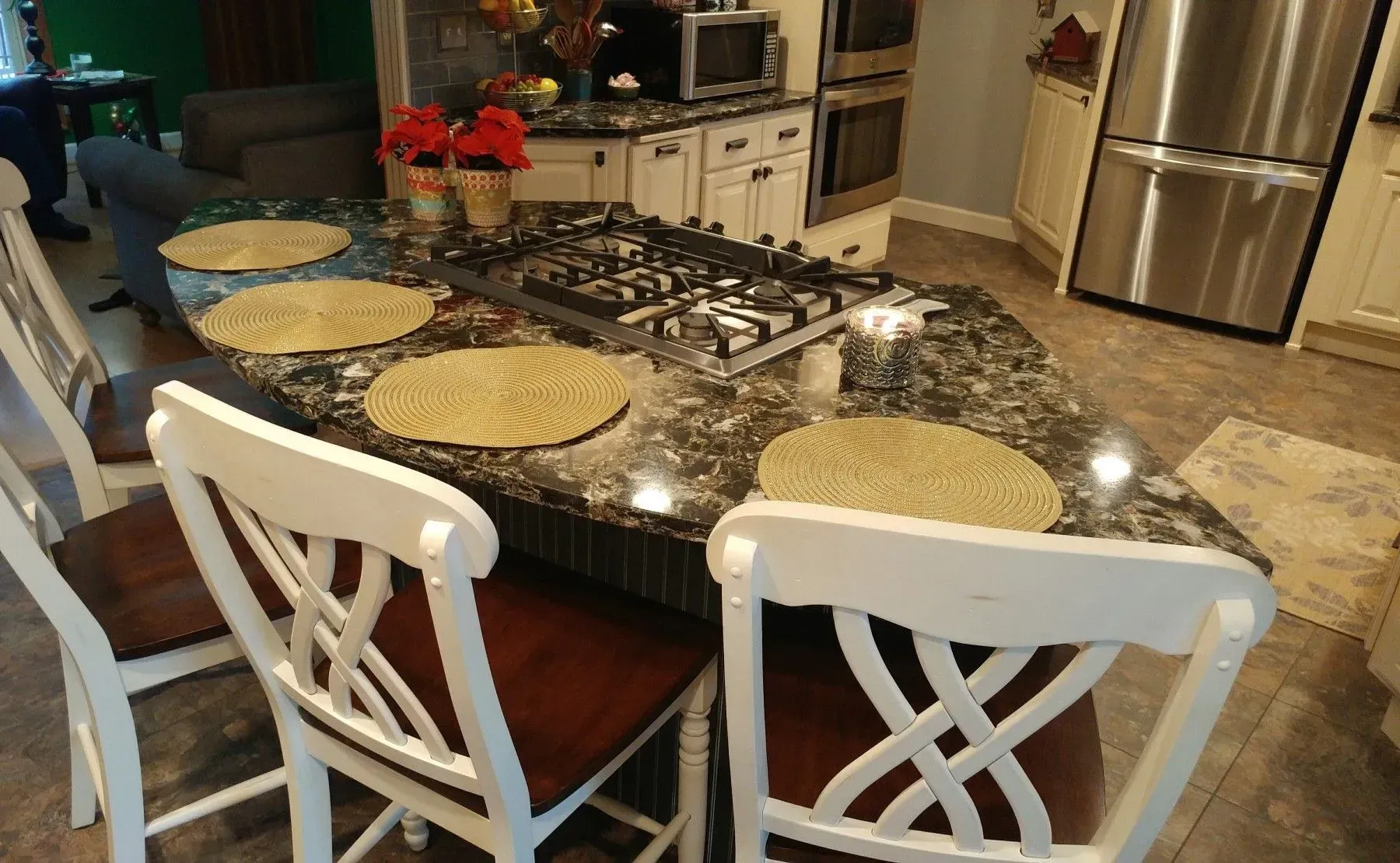 A kitchen with a table and chairs and a stove top oven.