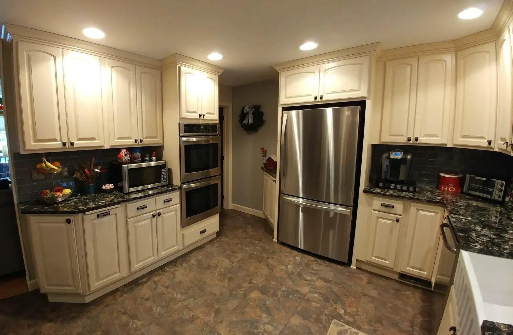 A kitchen with white cabinets and stainless steel appliances.