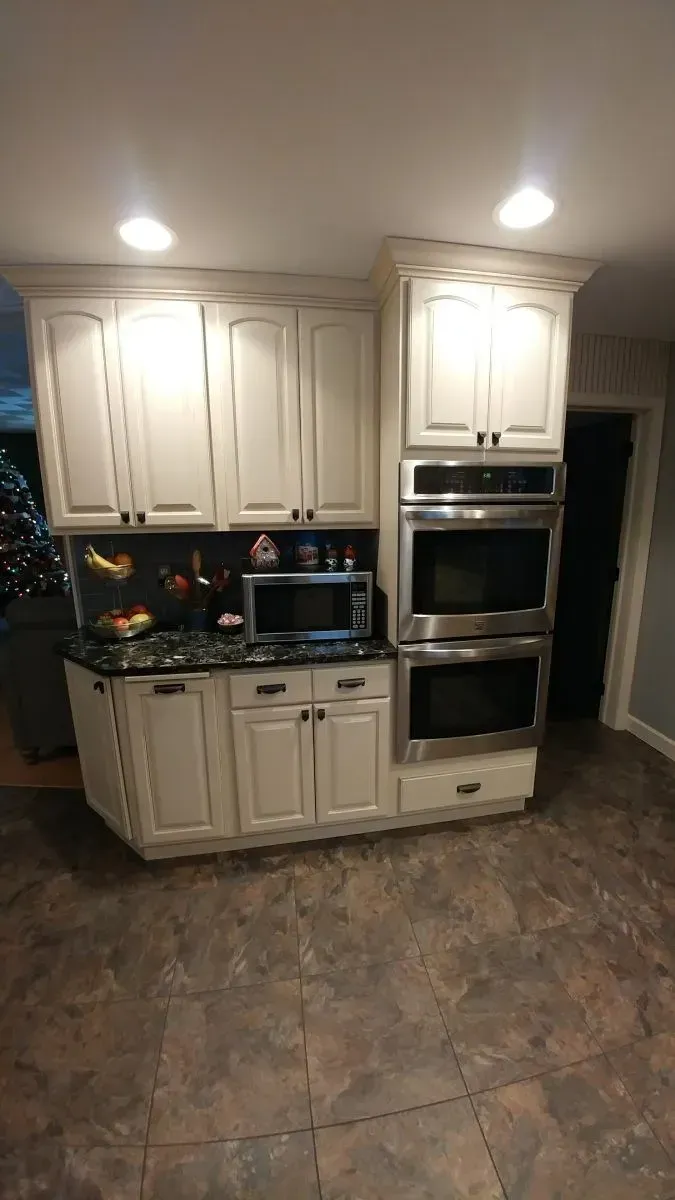 A kitchen with white cabinets and stainless steel appliances.