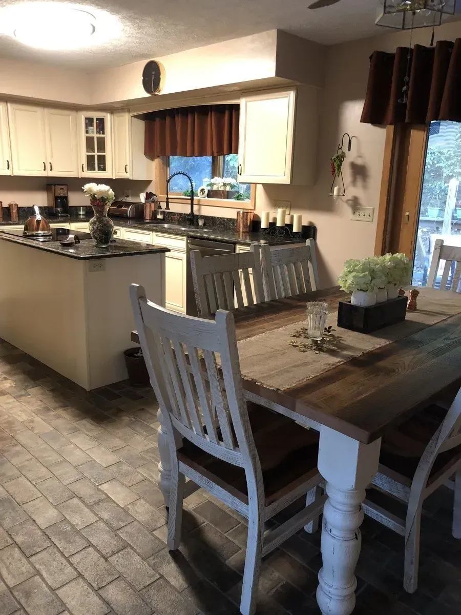 A kitchen with a table and chairs in it